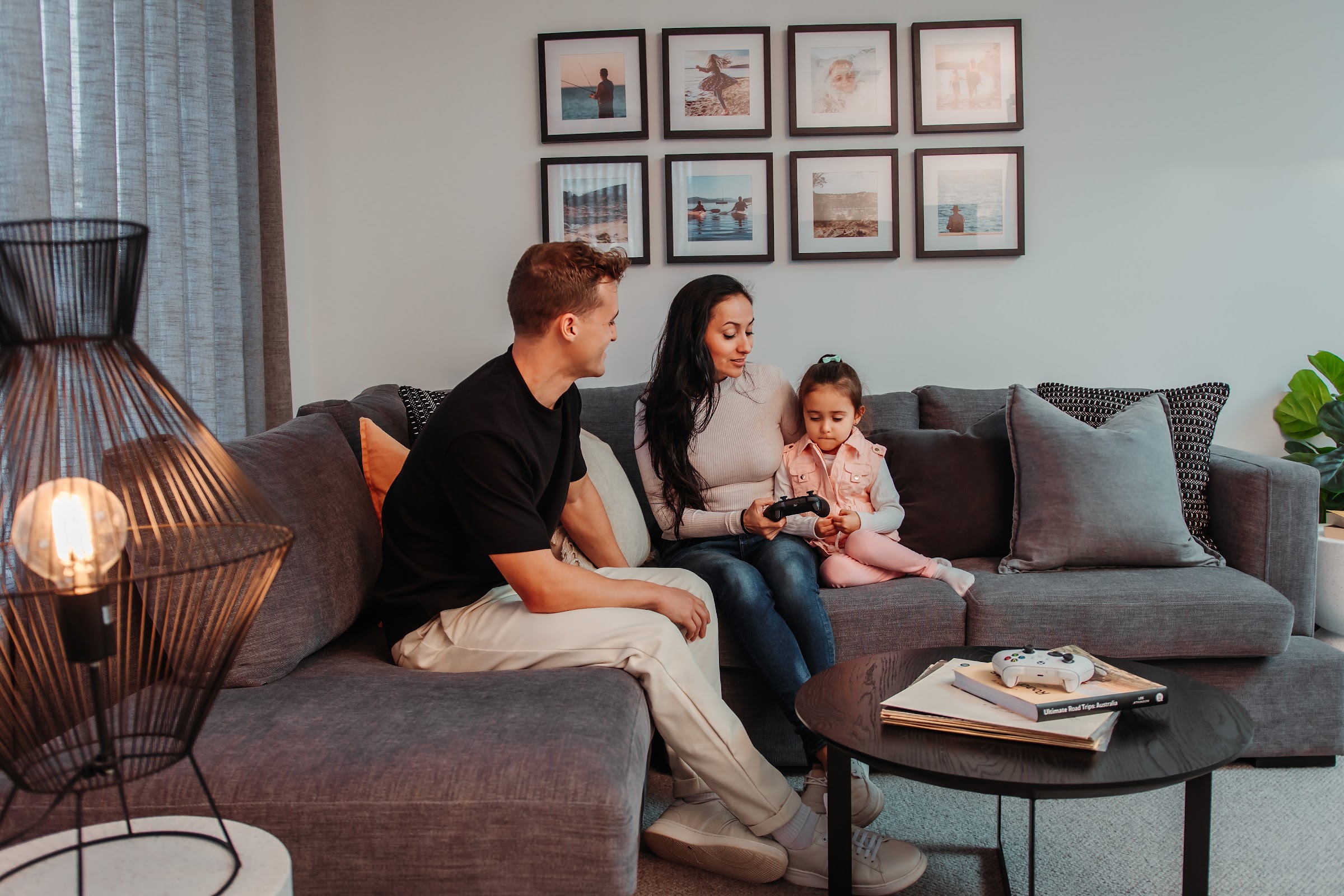 Young family talking together on the lounge at home