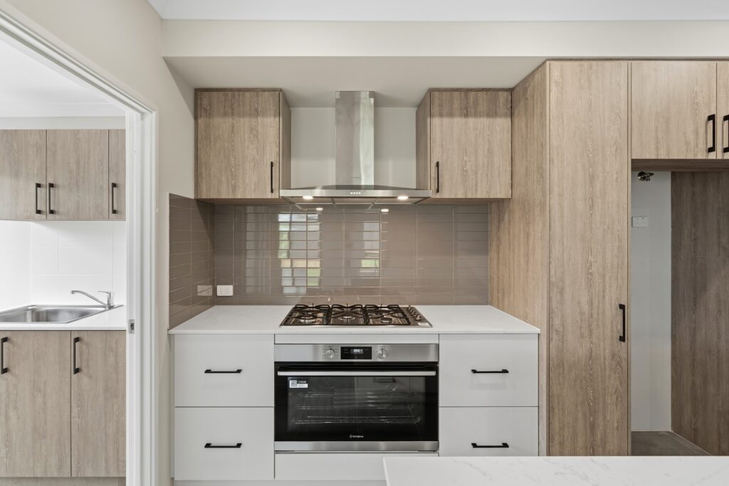 Kitchen in a completed Forma home with timber-look cabinetry