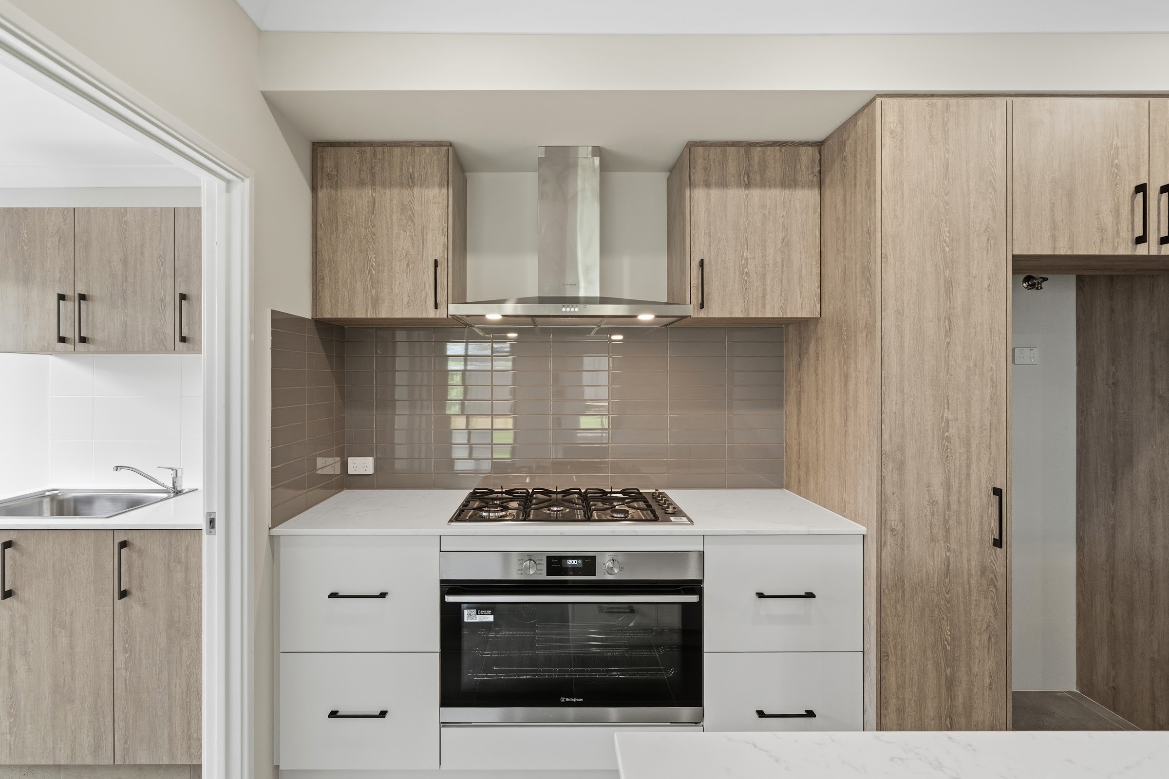 Kitchen in a completed Forma home with timber-look cabinetry